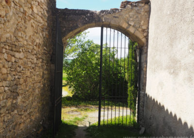 Portail ancien en fer forgé, voûte en pierres, à l'entrée de la cour, maison gérée par l'agence Provence Home care